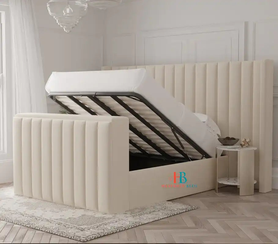 Cream upholstered tv bed with oversized headboard and storage made by heavenlybeds