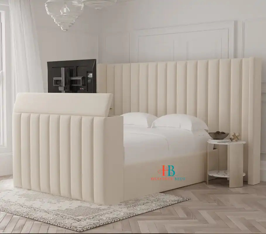 Beige upholstered tv bed with oversized headboard and storage made by heavenlybeds